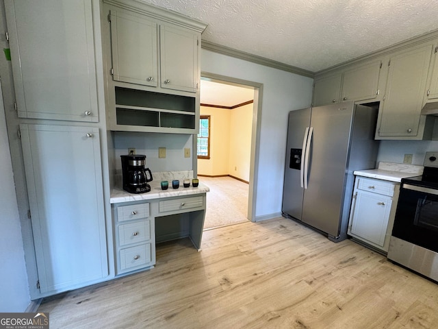 5307 Red Rock Trce, Powder Springs, GA 30127 - kitchen with appliances with stainless steel finishes, light countertops, light wood finished floors, ornamental molding, and gray cabinetry