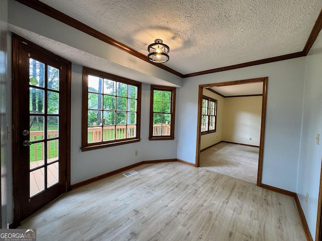 5307 Red Rock Trce, Powder Springs, GA 30127 - spare room with a textured ceiling, light wood-style flooring, ornamental molding, and baseboards