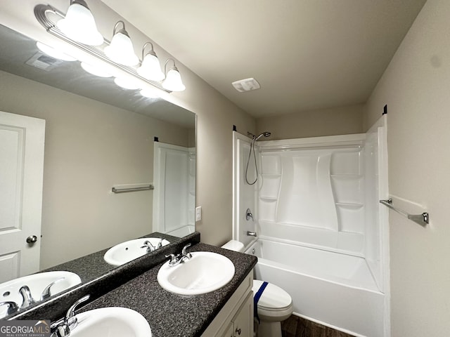 full bath featuring a sink, double vanity, and toilet