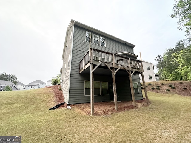 rear view of house featuring a deck and a lawn