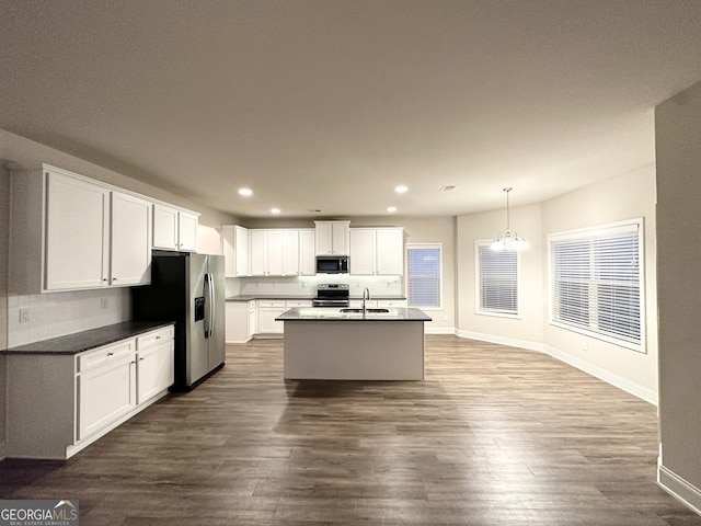 kitchen with recessed lighting, baseboards, a sink, white cabinetry, and appliances with stainless steel finishes