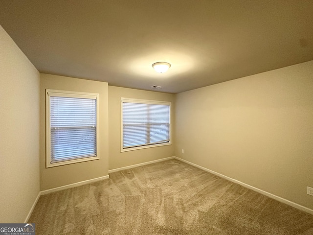 empty room with baseboards and carpet floors