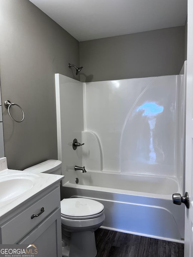 201 Jones St, Dalton, GA 30720 - bathroom with vanity, toilet,  shower combination, and wood finished floors