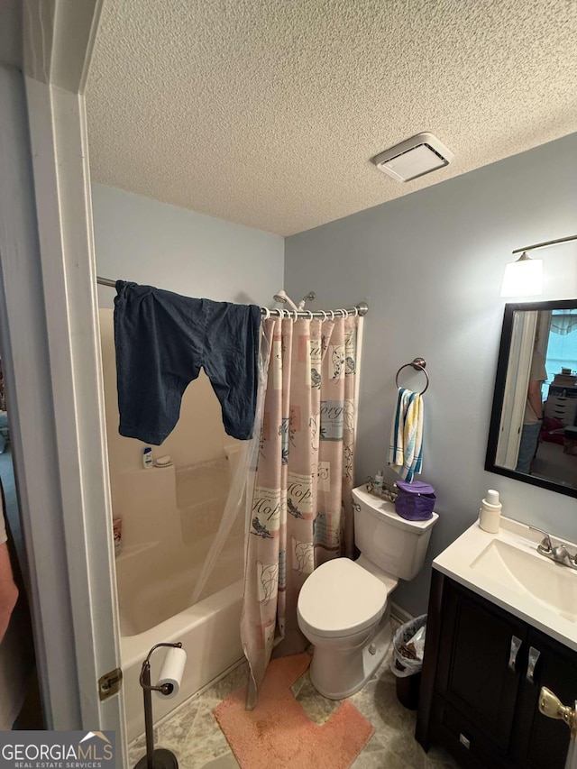 full bathroom with shower / tub combo with curtain, vanity, a textured ceiling, and toilet