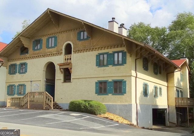 view of building exterior with uncovered parking