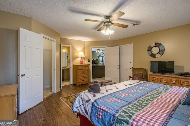 bedroom featuring a textured ceiling, visible vents, wood finished floors, and a ceiling fan