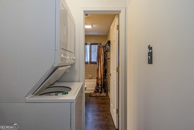 washroom with stacked washer / dryer, laundry area, and dark wood-style floors
