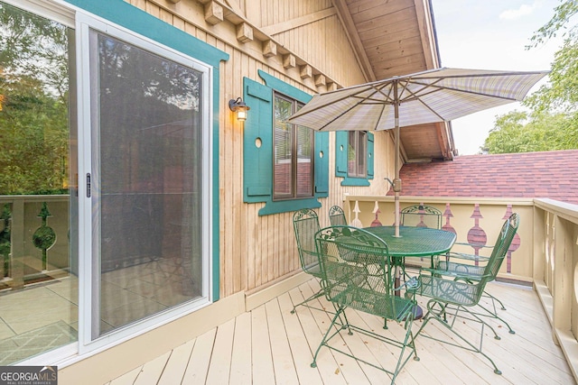 wooden deck featuring outdoor dining space