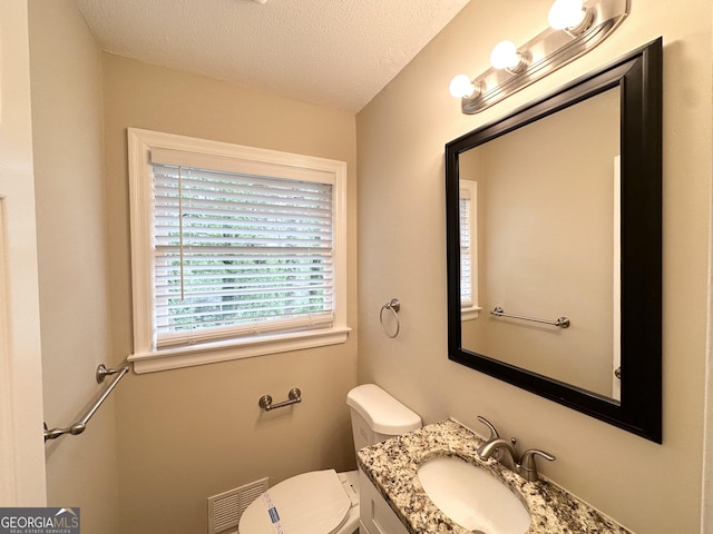 1814 Mary Lou Ln SE, Atlanta, GA 30316 - bathroom with toilet, vanity, visible vents, and a textured ceiling