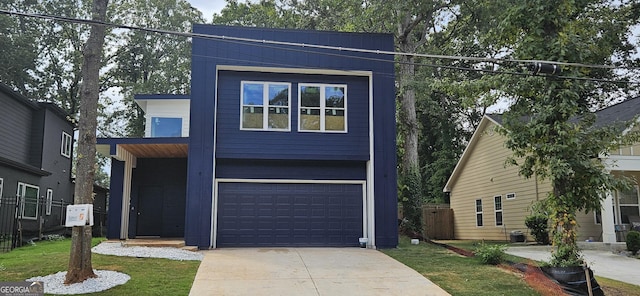 contemporary home featuring concrete driveway and a garage