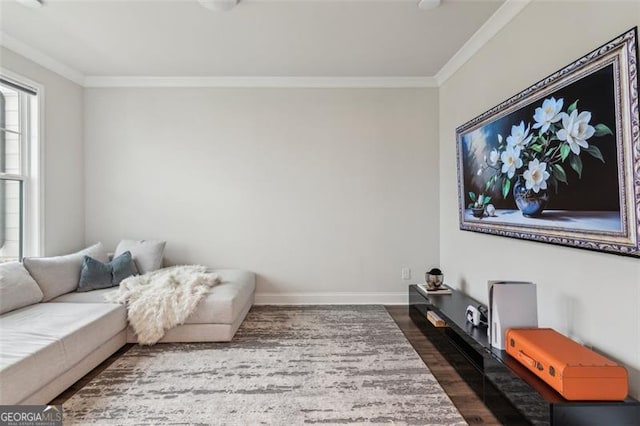 living room featuring wood finished floors, crown molding, and baseboards