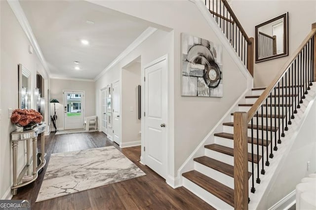 foyer with ornamental molding, stairway, wood finished floors, recessed lighting, and baseboards