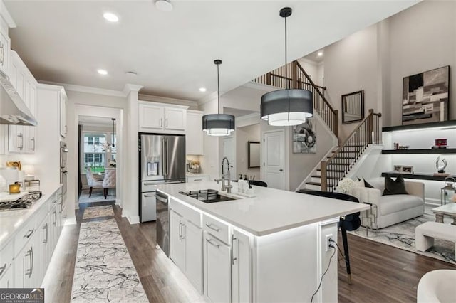 kitchen featuring appliances with stainless steel finishes, recessed lighting, ornamental molding, white cabinets, and light countertops
