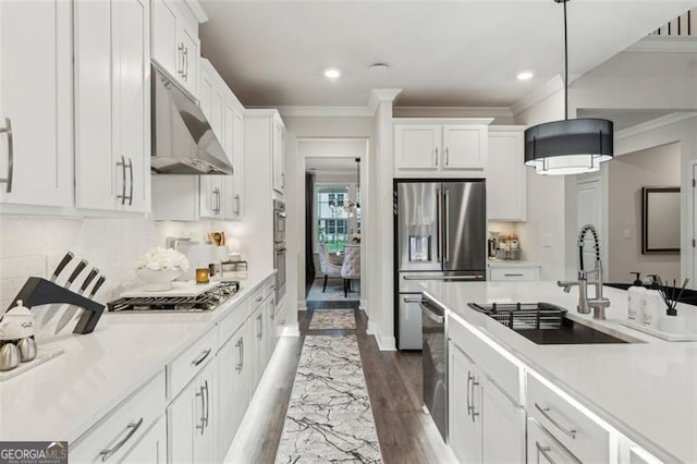 kitchen featuring stainless steel appliances, under cabinet range hood, a sink, crown molding, and light countertops