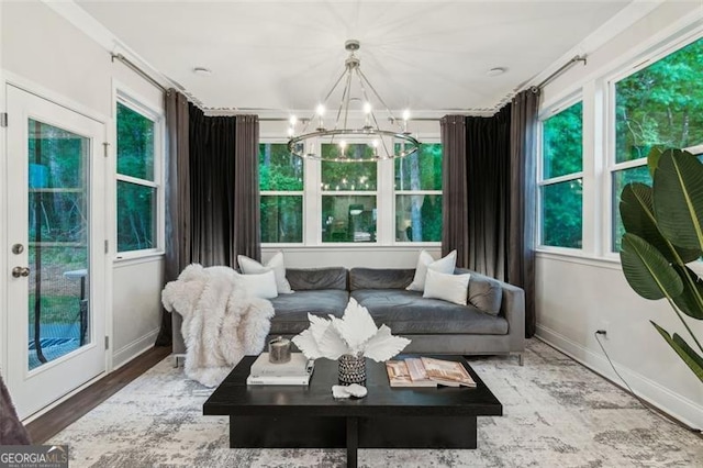 sunroom / solarium with a chandelier and healthy amount of natural light