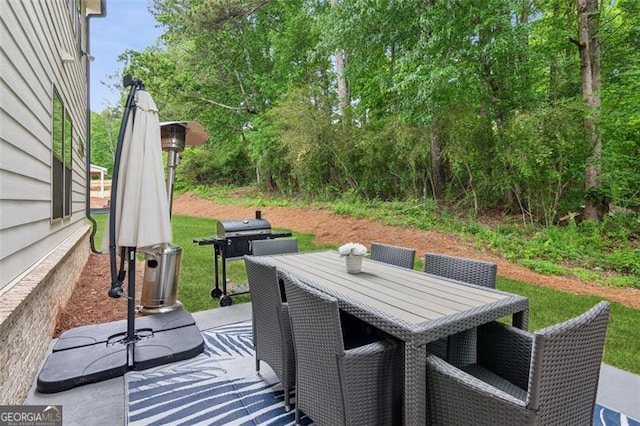 view of patio with grilling area and outdoor dining area