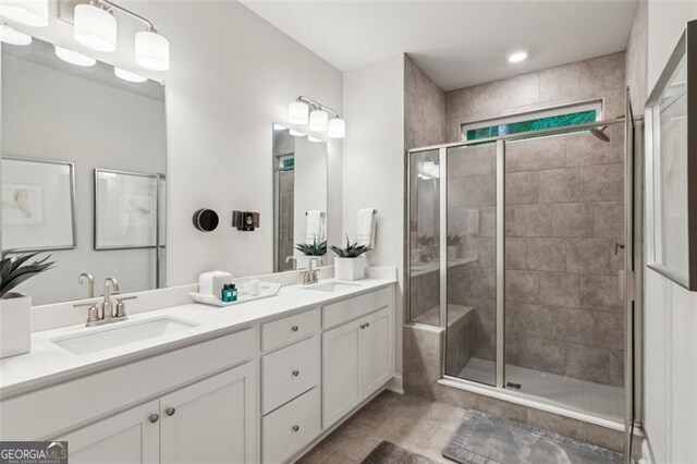 bathroom featuring a shower stall and double vanity