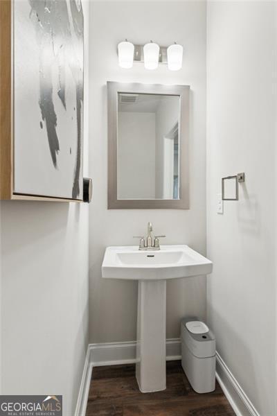 bathroom featuring wood finished floors and baseboards