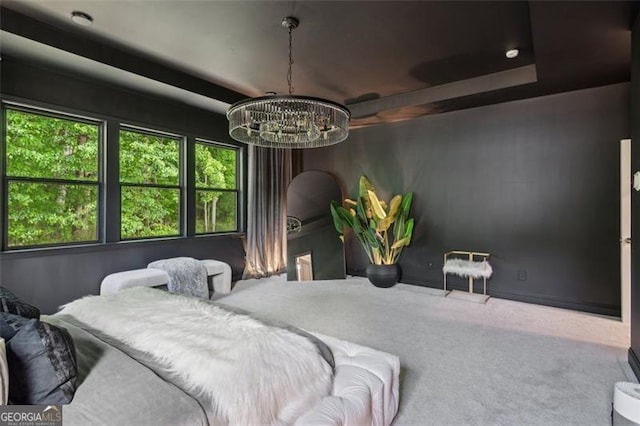 carpeted bedroom featuring a chandelier