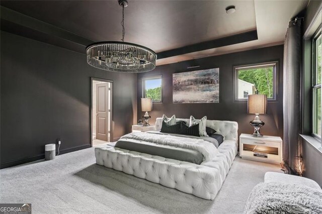 carpeted bedroom with a chandelier