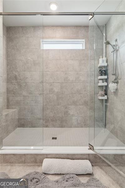 bathroom with tiled shower