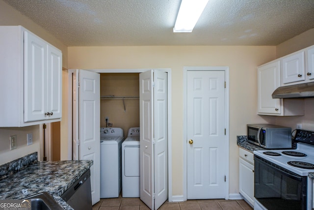 kitchen featuring range with electric stovetop, stainless steel microwave, under cabinet range hood, washing machine and dryer, and white cabinets
