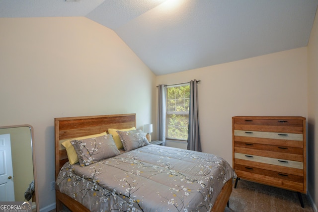 bedroom featuring lofted ceiling and carpet