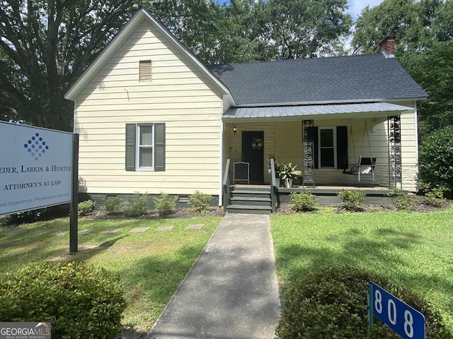 808 S Broad St, Monroe, GA 30655 - bungalow featuring covered porch, crawl space, a chimney, a shingled roof, and a front lawn