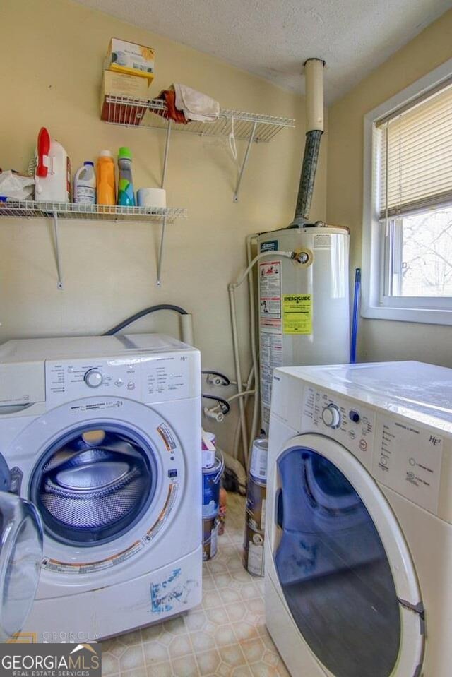 808 S Broad St, Monroe, GA 30655 - clothes washing area featuring washing machine and clothes dryer, laundry area, a textured ceiling, and gas water heater