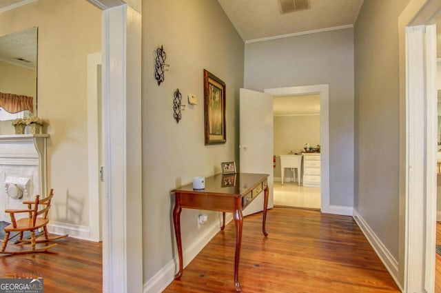 808 S Broad St, Monroe, GA 30655 - corridor featuring crown molding, visible vents, and wood finished floors