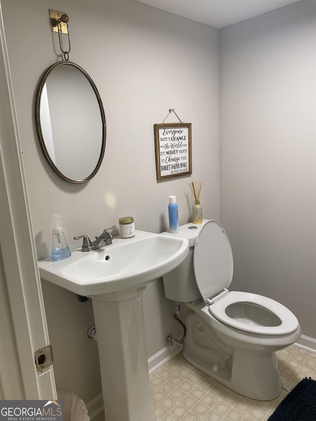 808 S Broad St, Monroe, GA 30655 - bathroom featuring baseboards, tile patterned floors, and toilet