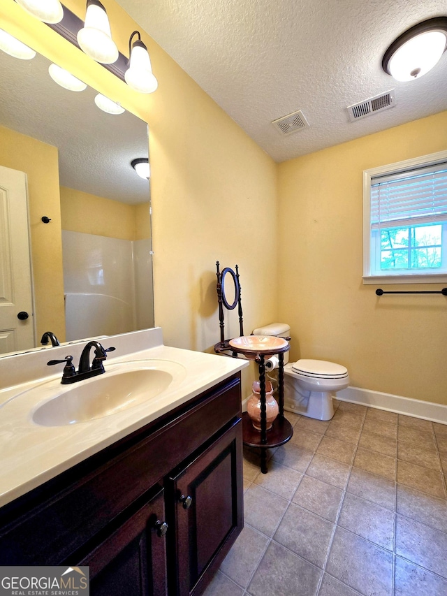 bathroom featuring walk in shower, a textured ceiling, visible vents, and tile patterned floors