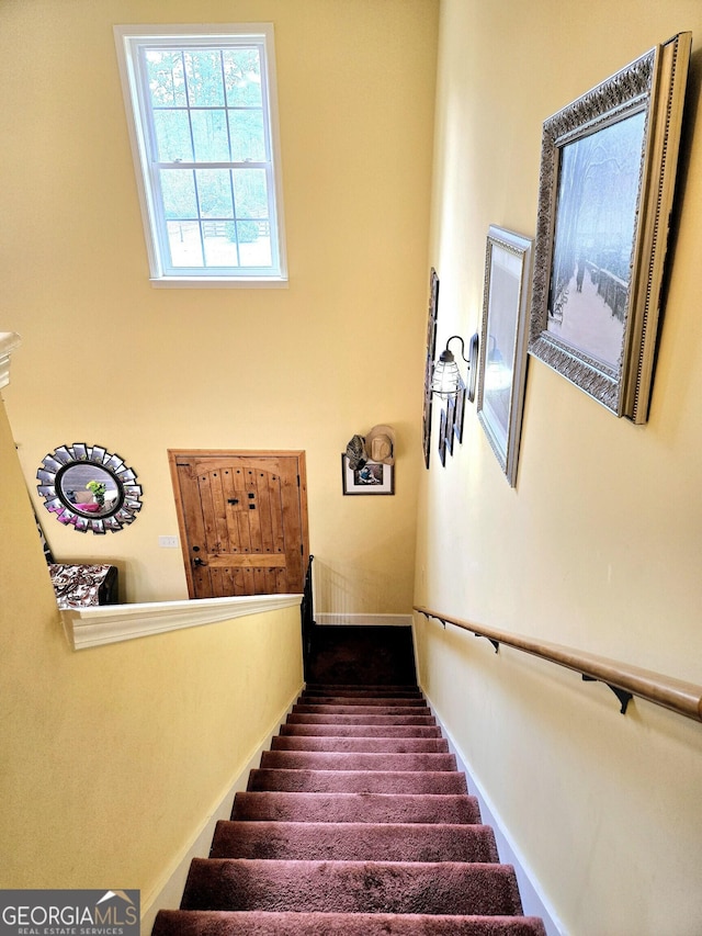 stairway featuring baseboards