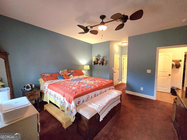carpeted bedroom featuring ceiling fan and baseboards