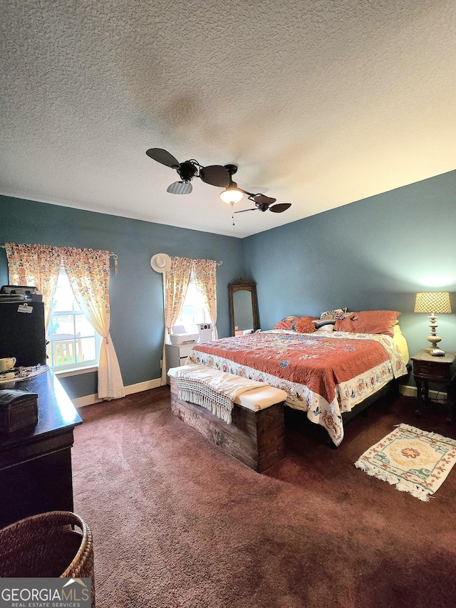 carpeted bedroom featuring ceiling fan, a textured ceiling, and baseboards