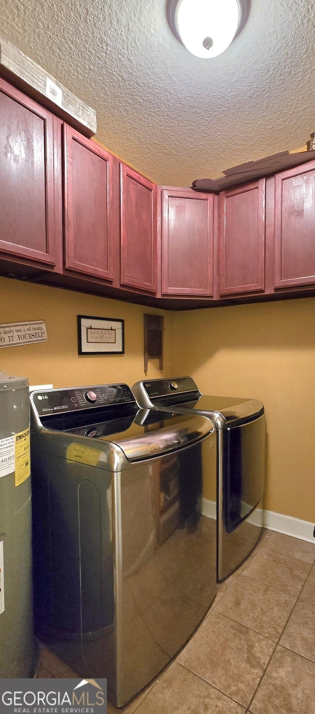 washroom with cabinet space, tile patterned floors, water heater, a textured ceiling, and independent washer and dryer
