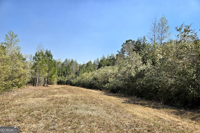 view of landscape with a forest view
