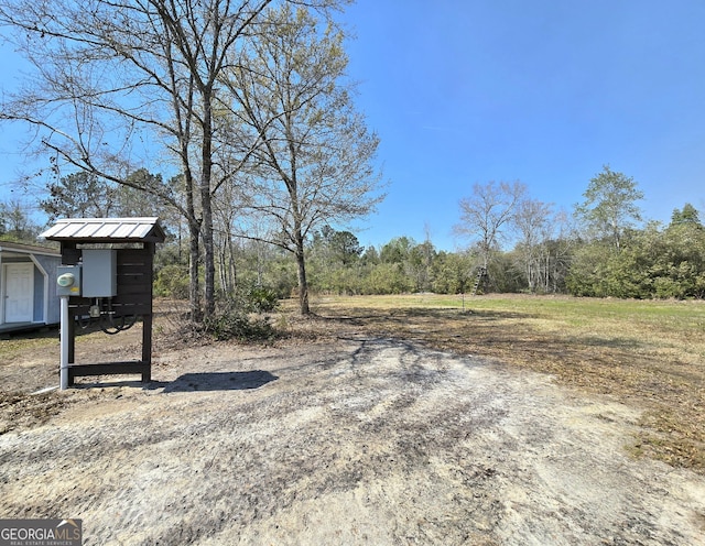 view of yard with a view of trees