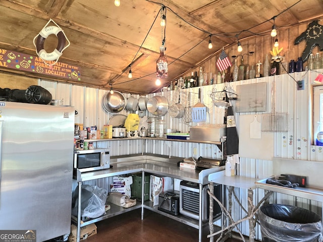 kitchen with lofted ceiling, wood ceiling, and appliances with stainless steel finishes