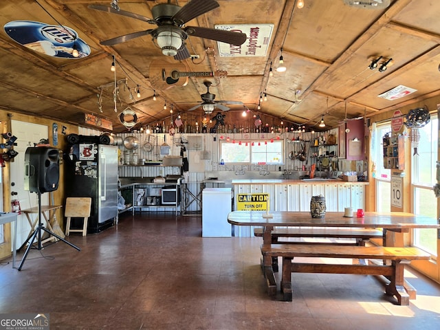 kitchen with a healthy amount of sunlight, ceiling fan, and vaulted ceiling