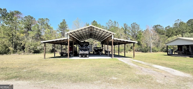 exterior space with a yard, a carport, and driveway