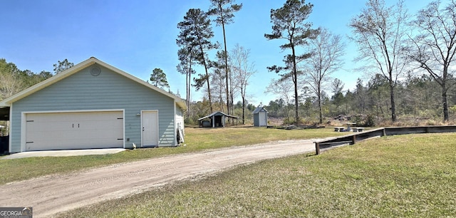 view of property exterior featuring a yard, a garage, dirt driveway, and an outbuilding