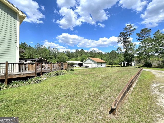 view of yard featuring a deck and a garage