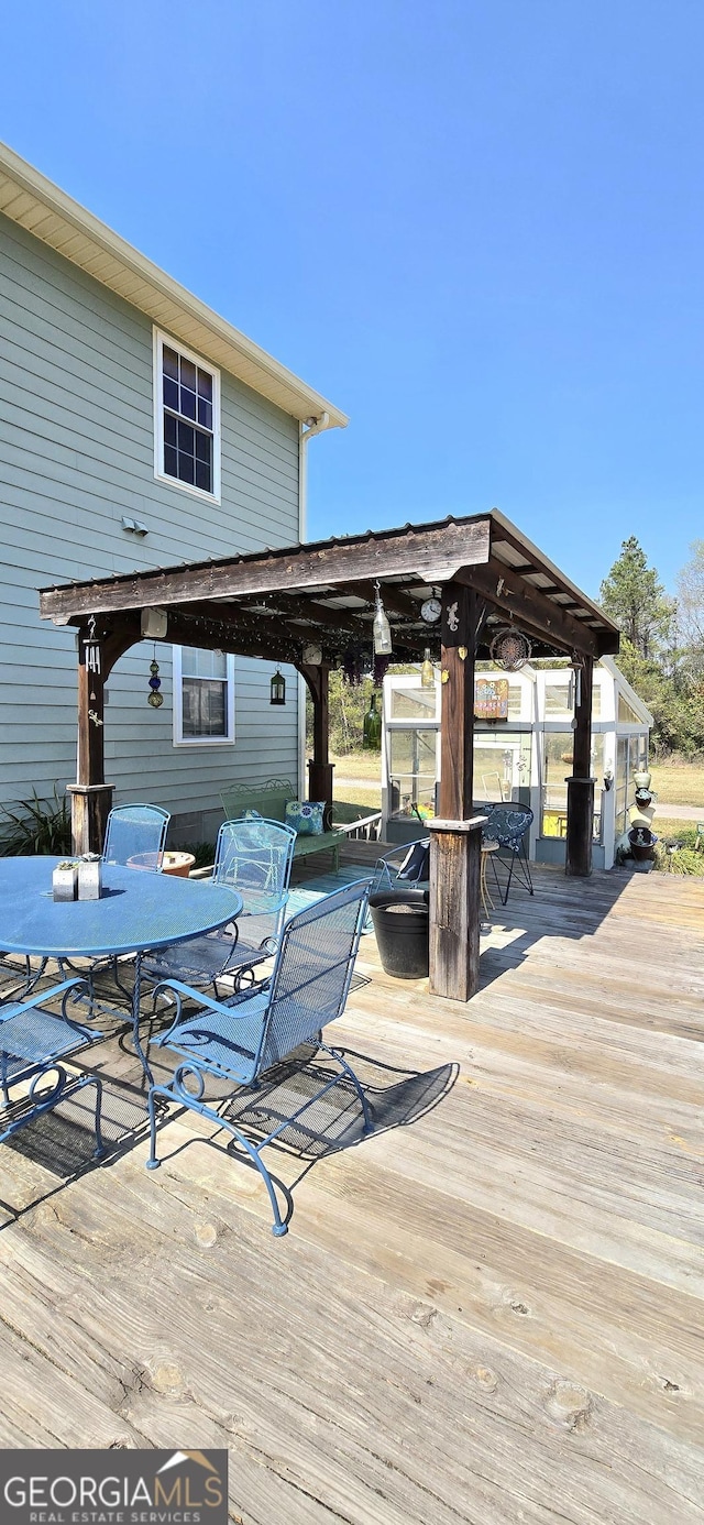 deck with outdoor dining area