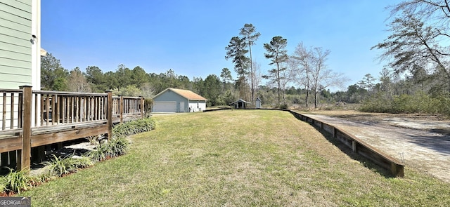 view of yard with a wooden deck and a garage