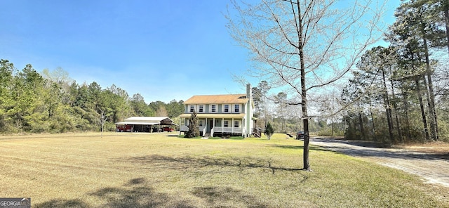 view of front of property featuring a detached carport, a porch, and a front yard