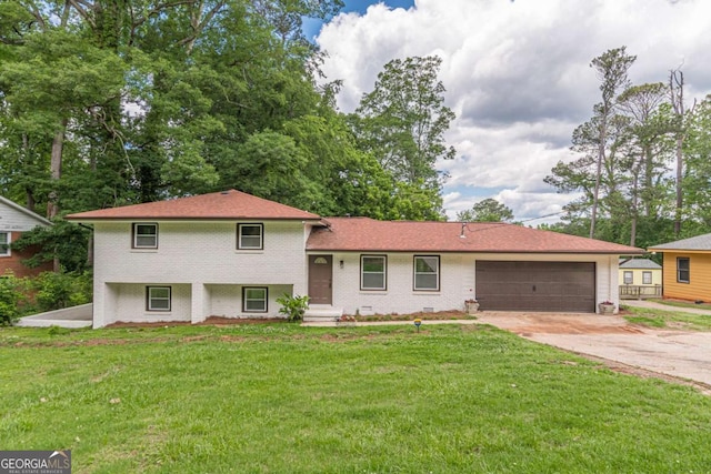 3275 Clifton Church Rd SE, Atlanta, GA 30316 - split level home featuring concrete driveway, a garage, brick siding, and a front yard