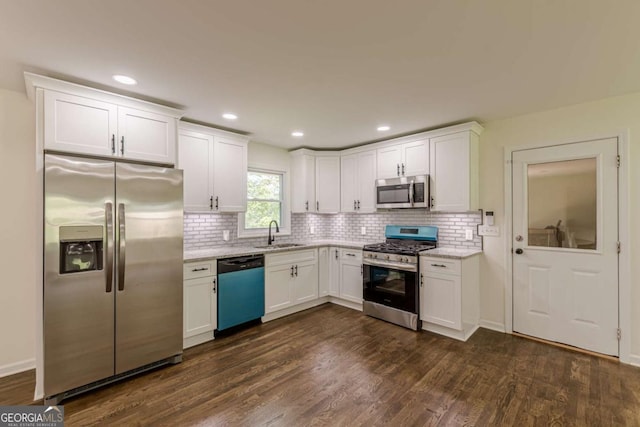 3275 Clifton Church Rd SE, Atlanta, GA 30316 - kitchen with a sink, stainless steel appliances, white cabinets, backsplash, and dark wood-style floors