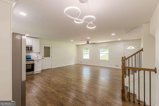3275 Clifton Church Rd SE, Atlanta, GA 30316 - unfurnished living room with dark wood-type flooring, ceiling fan with notable chandelier, and recessed lighting