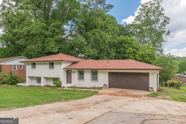3275 Clifton Church Rd SE, Atlanta, GA 30316 - tri-level home with an attached garage, brick siding, driveway, and a front yard